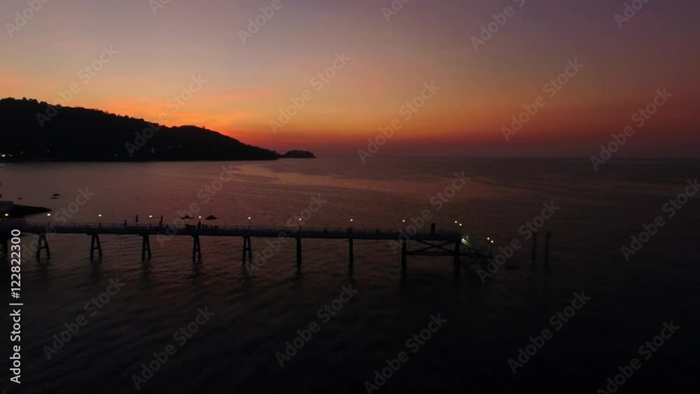 The drone passes over a pier. Shooting with drone at sunset in a bay. The drone passes over a pier. Shooting with drone at sunset in a bay.