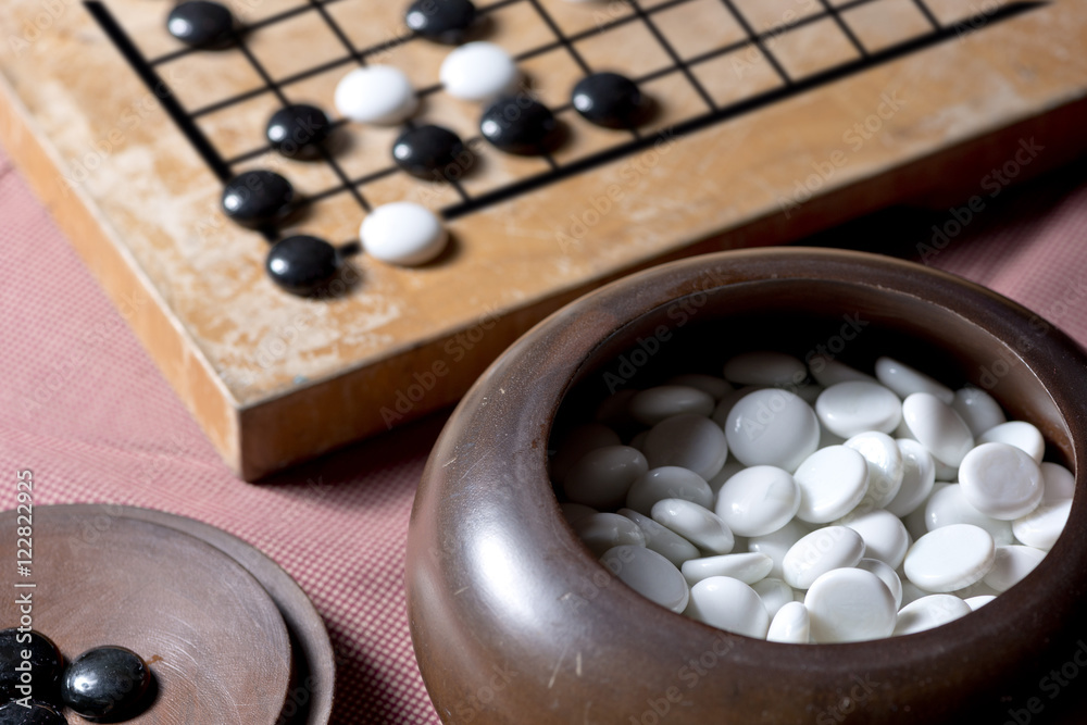 Stones on a Go board,traditional chinese strategy board game. Stones on a Go board,traditional chinese strategy board game.