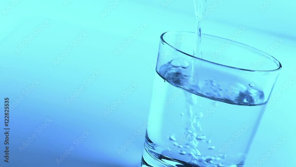 filling a glass with water, nutrition and health-care concept filling a glass with water, nutrition and health-care concept
