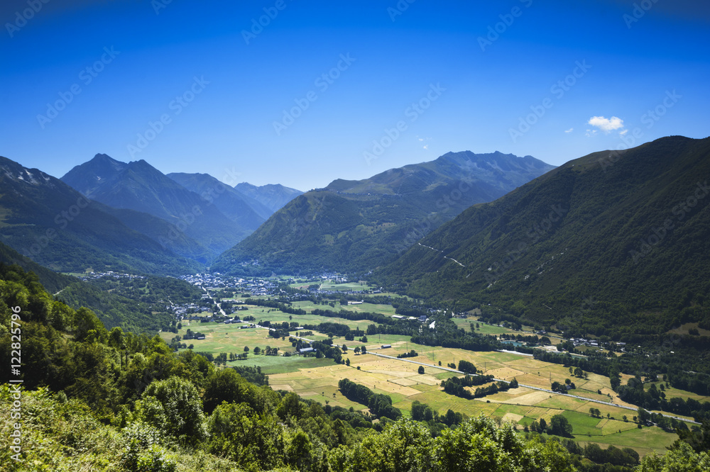 Valley and peak of Pyrenean mountains with a blue sky, France