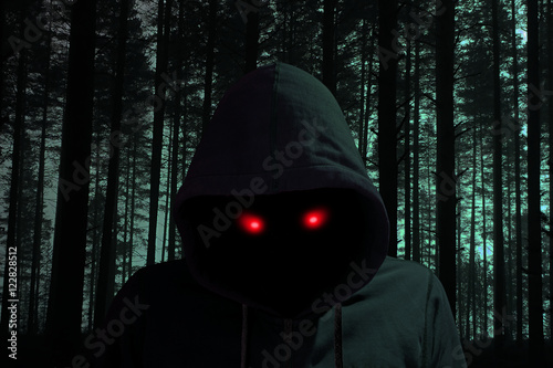 Dark man with hoddie in black forest red eyes