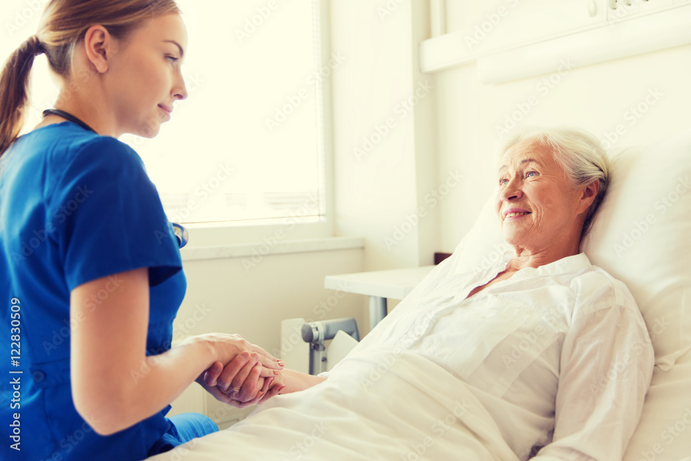 Fototapeta premium doctor or nurse visiting senior woman at hospital
