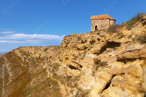 Ancient building on top of the hill and Udabno caves (to the left) , part of rock-hewn Georgian Orthodox monastery complex David Gareja