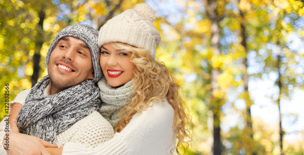 happy couple in warm clothes over autumn happy couple in warm clothes over autumn