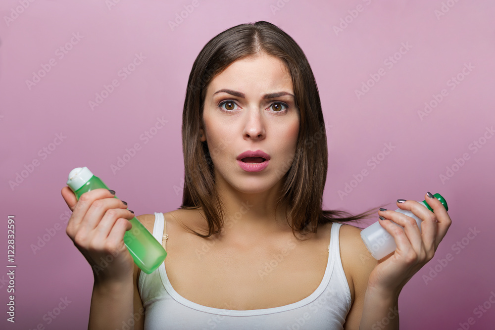 Pretty woman choosing a skin care product Pretty woman choosing a skin care product
