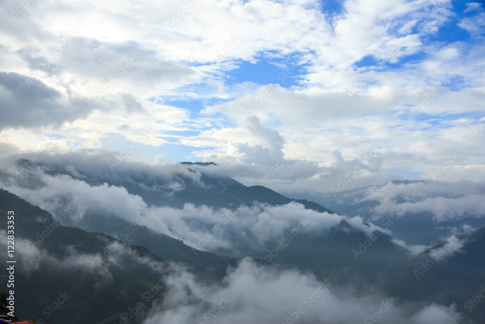 Mountain landscape with peaks covered by clouds