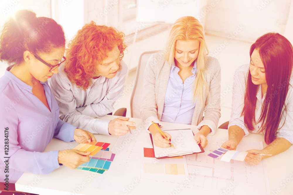 Fototapeta premium team with color samples and blueprint at office