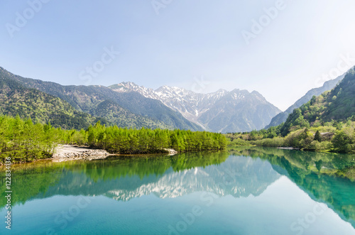 Hotaka mountain range and taisho ike pond in spring at kamikochi national park nagano japan