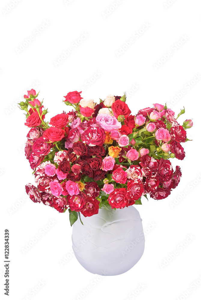 Big bouquet of pink roses in glass vase isolated on white.