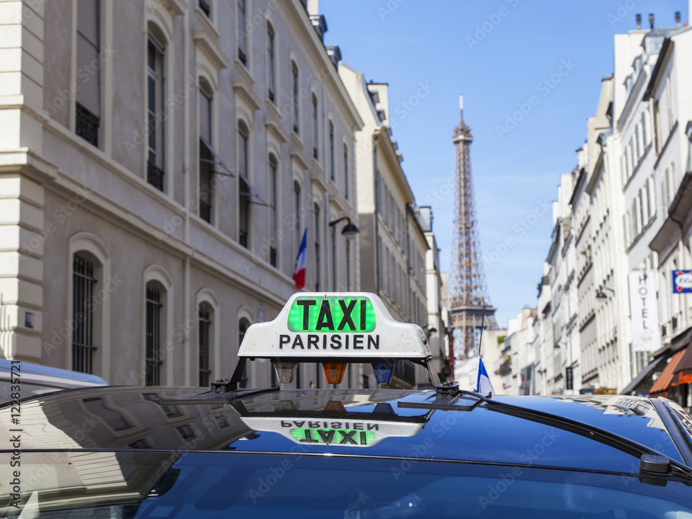 Naklejka premium PARIS, FRANCE, on JULY 9, 2016. The Parisian taxi against the background of typical city architecture