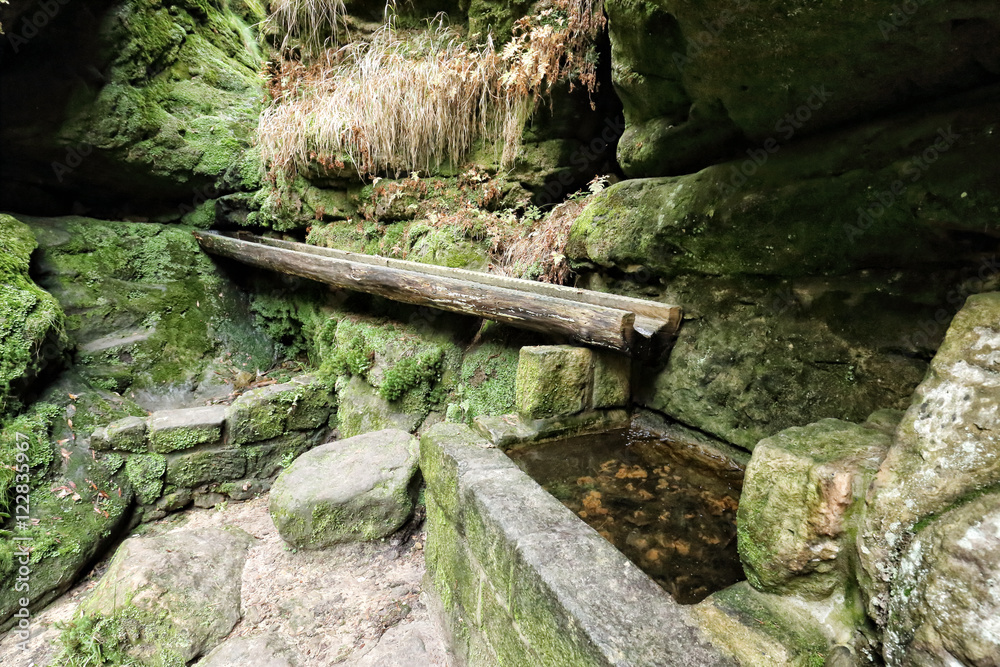 Old water spring with wooden eaves