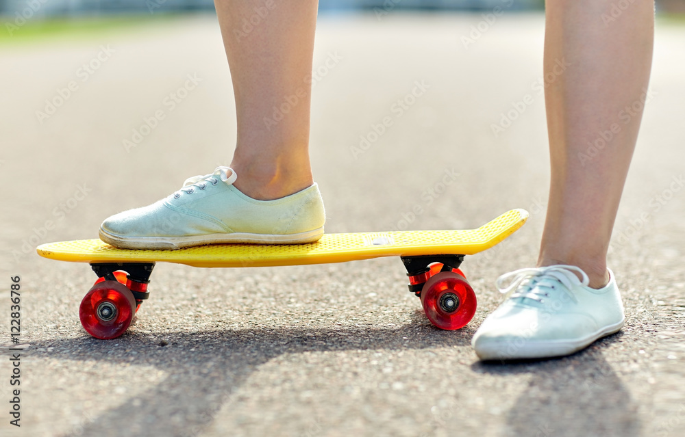 close up of female feet riding short skateboard close up of female feet riding short skateboard
