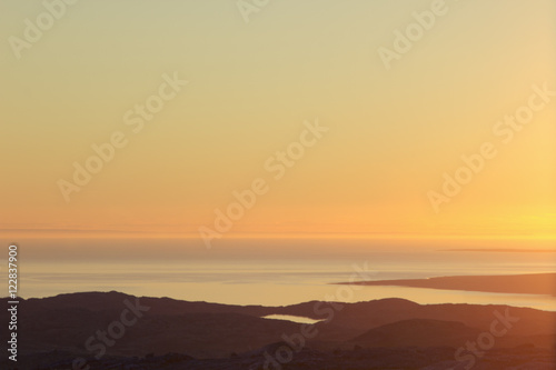 Beautiful soft sunset sky over mountain valley and sea. Arctic summer, the tundra, Norway.