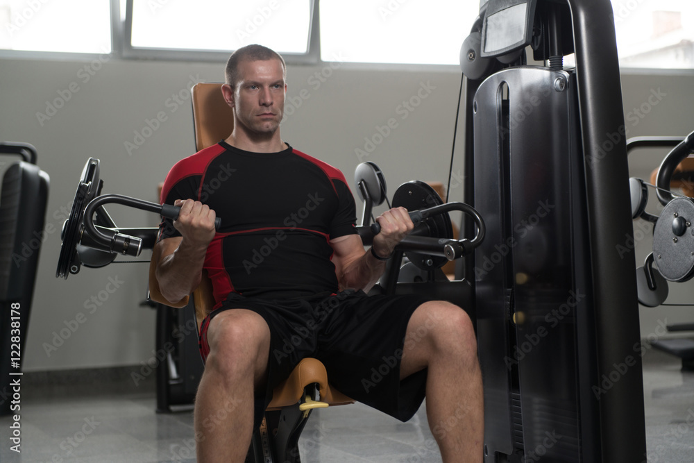 Healthy Man Doing Heavy Weight Exercise For Biceps