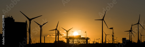 Emden Aussenhafen mit Windkraftwerke und sonnenuntergang photo