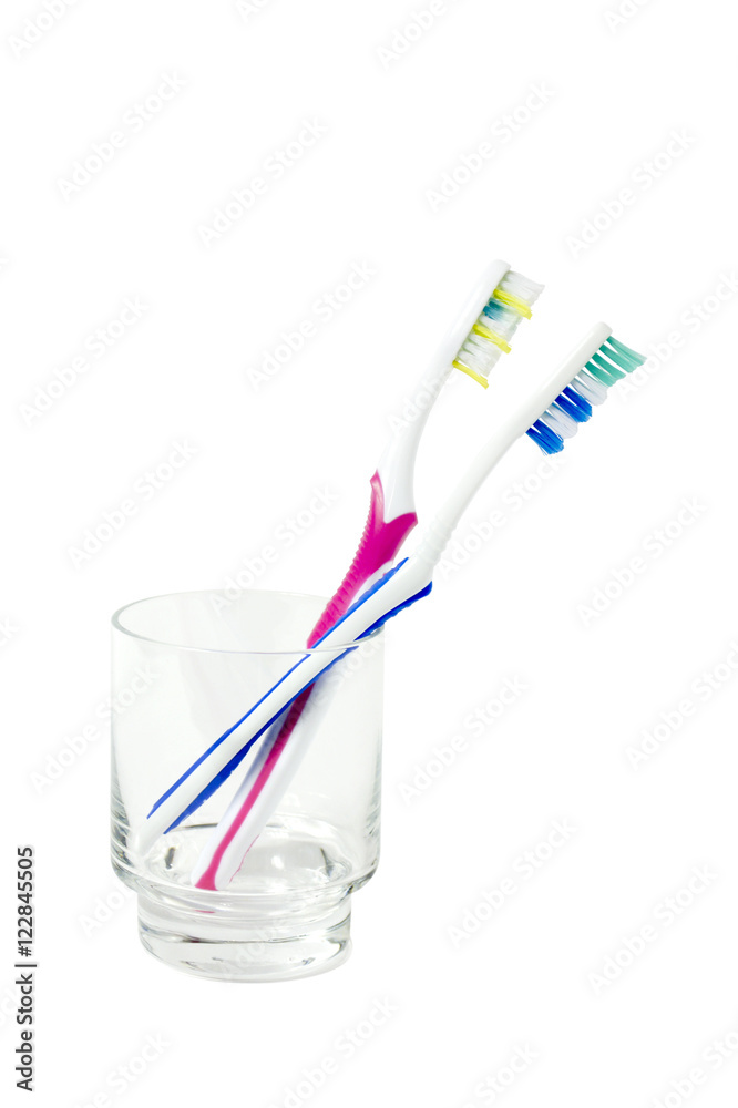 two toothbrushes in a glass isolated two toothbrushes in a glass isolated