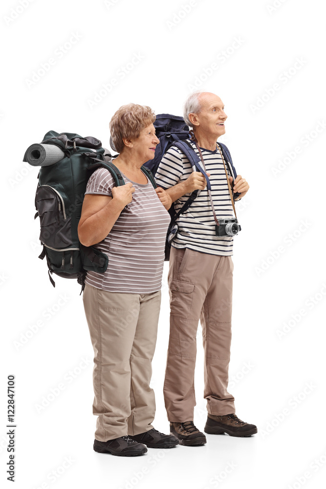 Two elderly hikers looking in the distance Two elderly hikers looking in the distance