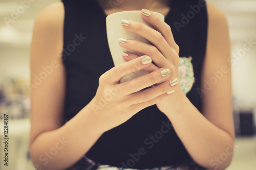 Cup in female hands