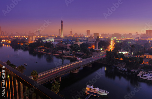 CAIRO - EGYPT - DECEMBER 2010: panorama of Cairo and Nile, movement in morning, sunrise, view from top, with Cairo Tower, buildings, auto and boats.