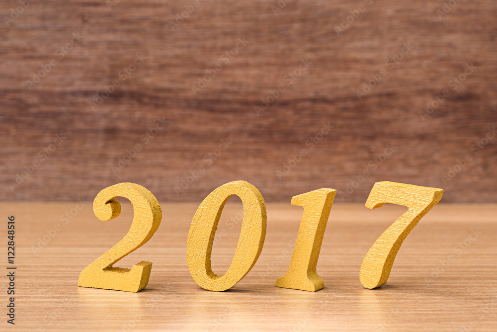 gold wooden font of year 2017 on wood table gold wooden font of year 2017 on wood table