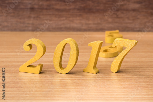 gold wooden font of year 2017 on wood table