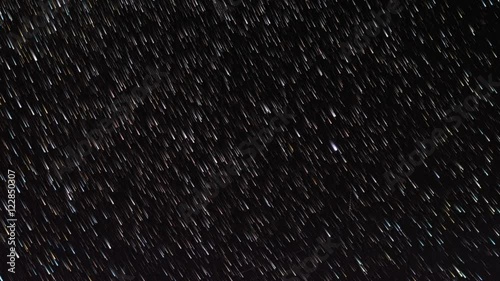 time-lapse of stars moving through the night sky, first as spots of light and then gradually as star trails 