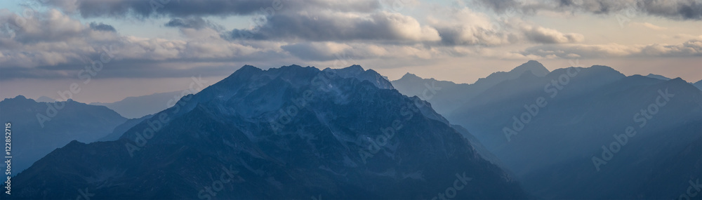 Panorama of mountains in light of evening sun. Greater Caucasus.