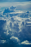 Beautiful sky with a lot of storm clouds and clouds of various forms during the flight. Aerial view through sky above the clouds abstract background.