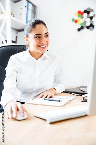 Businesswoman using laptop for work while sitting at the office