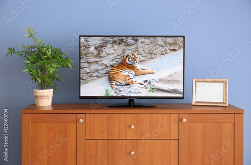 wide screen TV on wooden co...