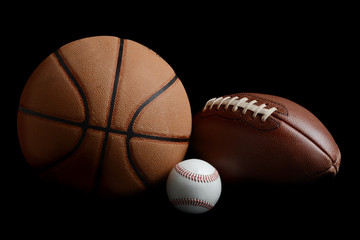 football,basketball,baseball on black background