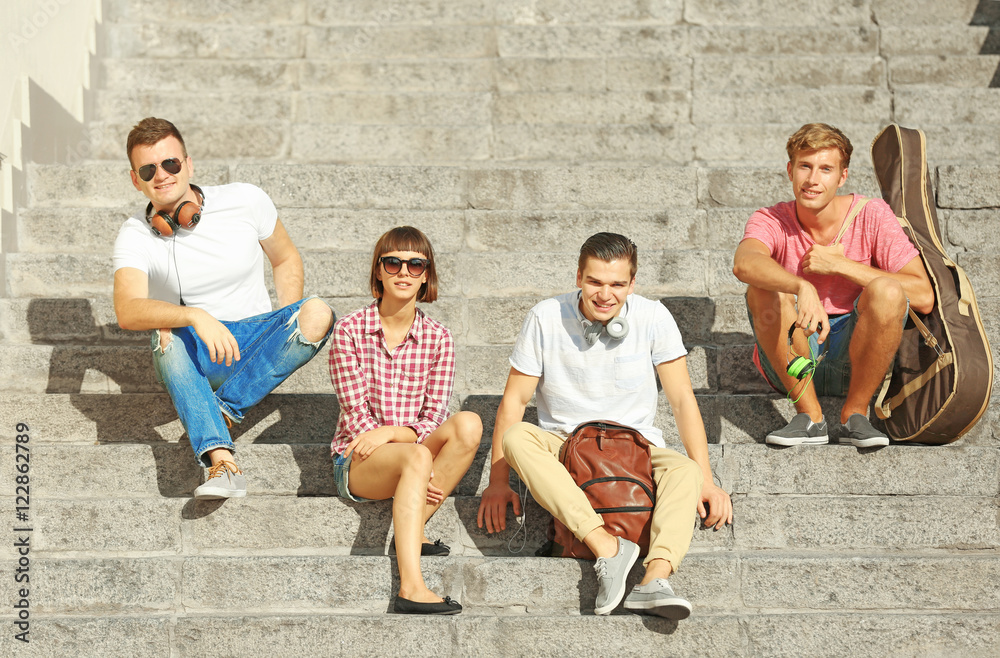 Fototapeta premium Happy friends hanging out on stairs