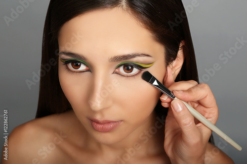 Makeup artist applying make...