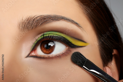 Makeup artist applying make...