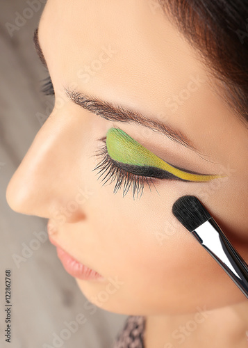 Makeup artist applying make...
