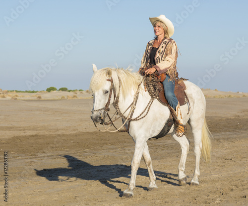 cowgirl on camargue horse