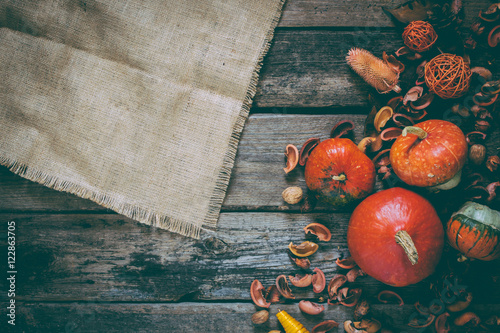 autumn decorated wooden table and sackcloth. top view.  photo