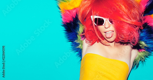 Fashion party time. Playful Girl with bright red hair and fur co photo