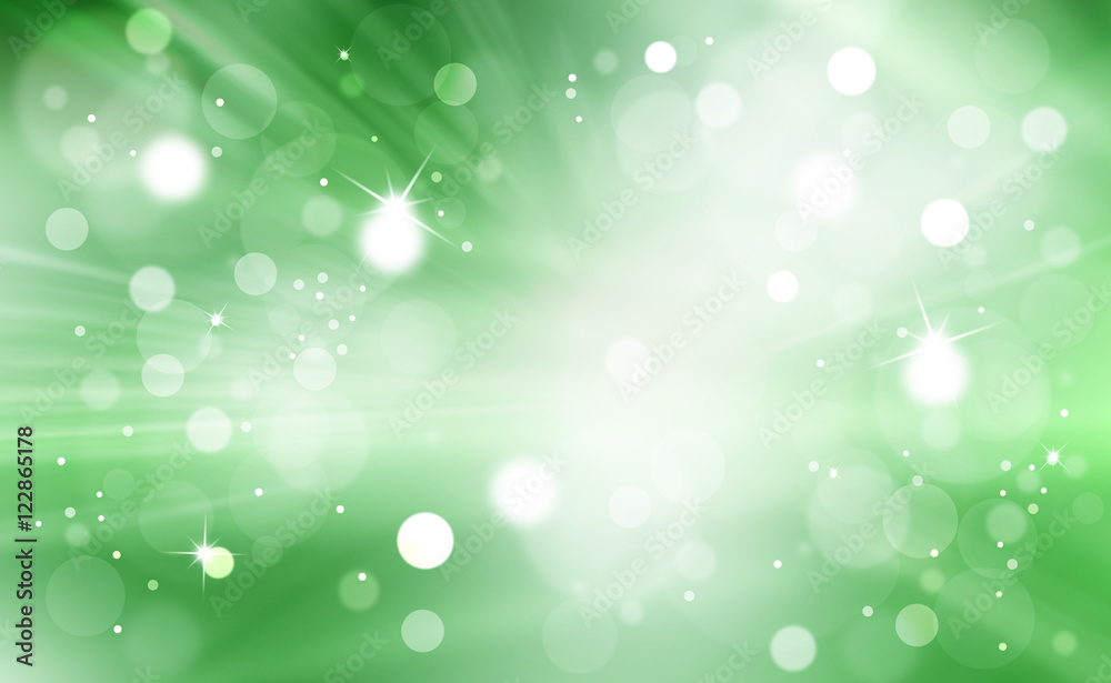 Artistic bright shiny gren color bokeh with light rays background. Abstract blurred Christmas and New Year greeting card illustration background with sparkle.