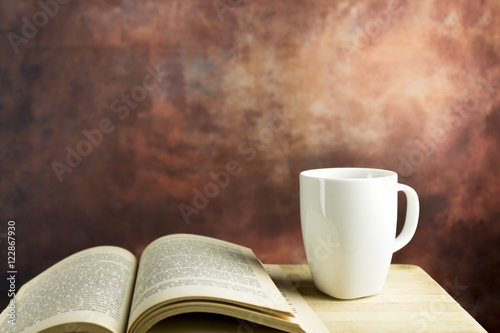 Coffee and book on wooden table