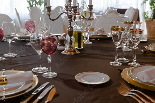 Rich bronse candlestick stand in the middle of festive dinner ta photo