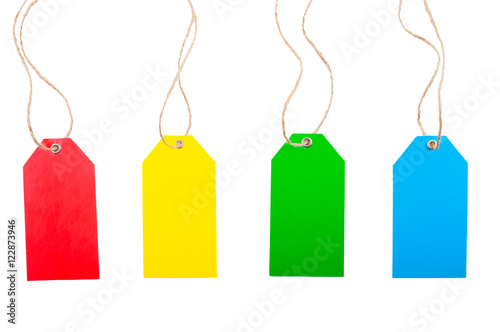 Colored price tags with rope on white, isolated background. Top view. Flat lay.