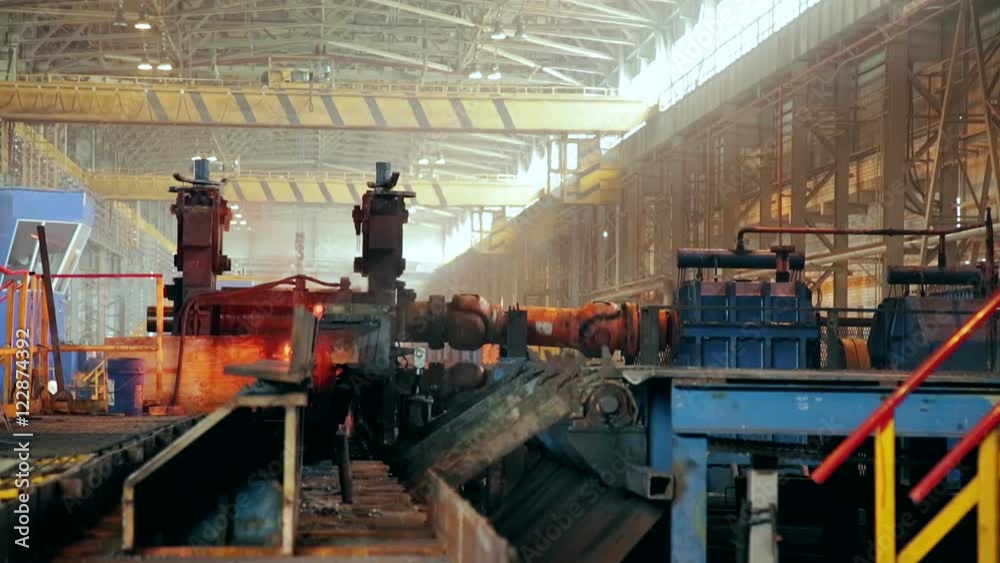Ironworks plant. Working Machines moves burning hot billet Ironworks plant. Working Machines moves burning hot billet
