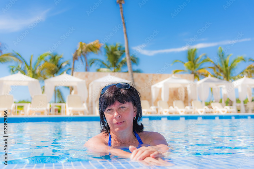 woman is lying near the pool
