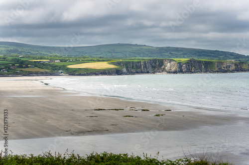 Fototapeta Naklejka Na Ścianę i Meble -  Deserted Sand Beach along the Coast of Wales on a Spring Cloudy Day