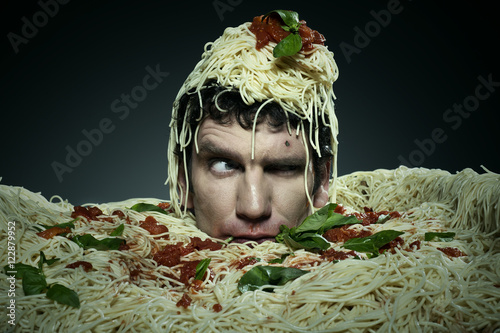 Man drowning in spaghetti.  photo