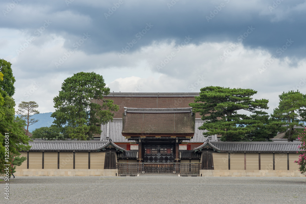 Kyoto, Japan - September 14, 2016: The south gate of the Imperial Palace is called the Kenrei-mon Gate. The roof of the Shishinden reception hall towers above it under heavy skies. Kyoto, Japan - September 14, 2016: The south gate of the Imperial Palace is called the Kenrei-mon Gate. The roof of the Shishinden reception hall towers above it under heavy skies.