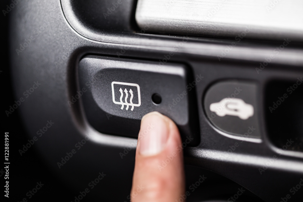 Car heater button with finger press.