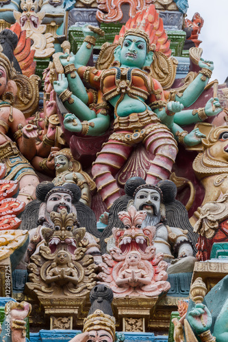 Madurai, India - October 19, 2013: Closeup of image representing the fierce goddess Kali also known as Durga. Facade of South Gopuram at Meenakshi Temple.