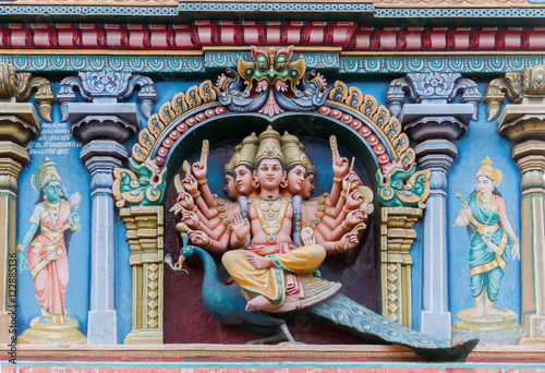 Madurai, India - October 19, 2013: Closeup of Lord Murugan. He sits on his mount the peacock and has multiple arms. Facade of Nagara Mandapam.
